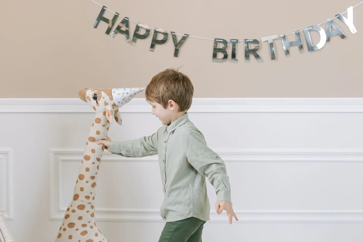 Enfant de 3 ans jouant avec une peluche girafe - jeux éducatifs